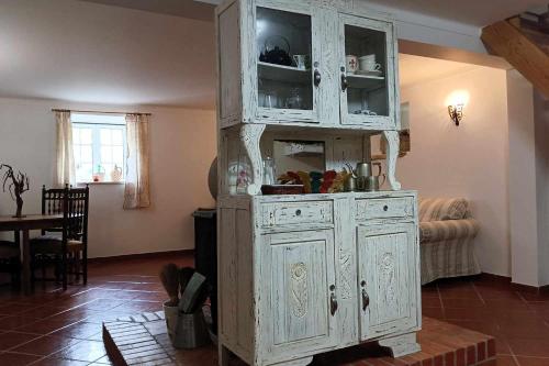 a large white cabinet in a living room at Casa do Trola - Ferreira do Zêzere in Águas Belas