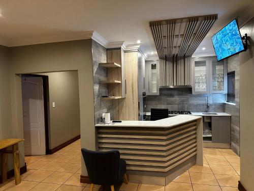 a kitchen with a island in the middle of a room at Urban Villas Guest House in Pretoria