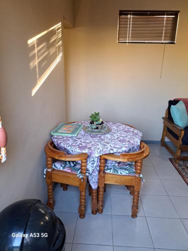 a table with two chairs and a table with a table cloth at 2FiftySix on Second in Lüderitz