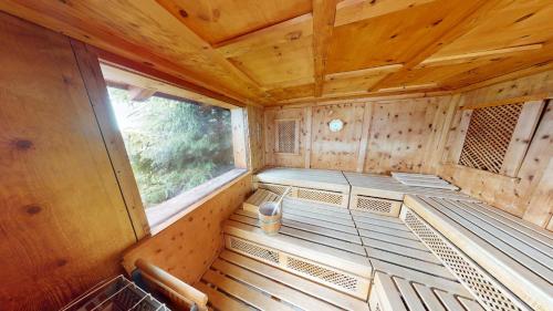 an empty interior of a wooden cabin with a window at Wellness Aparthotel Panorama Alpin - Ferienwohnungen Jerzens im Pitztal in Jerzens