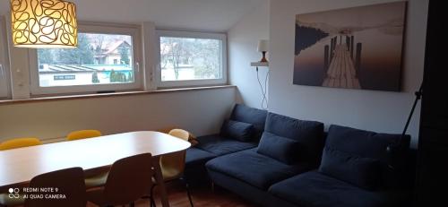 a living room with a couch and a table at Apartment na Gruszy in Stronie Śląskie