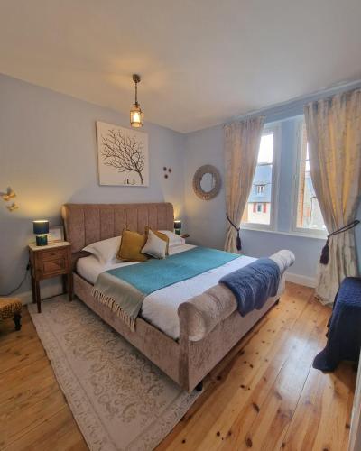 a bedroom with a large bed and a window at L'Ancien Poste in Sénergues