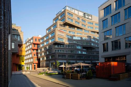 a tall building with a table in front of it at Scandic München Macherei in Munich