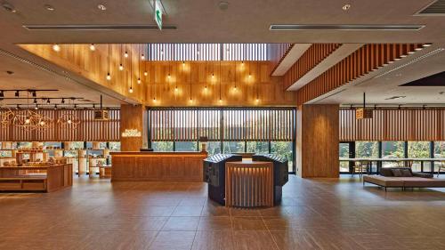 a large room with a lobby with tables and chairs at Hotel around Takayama, Ascend Hotel Collection in Takayama