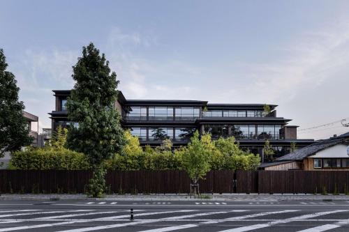 an office building with a tree in front of it at Garrya Nijo Castle Kyoto in Kyoto