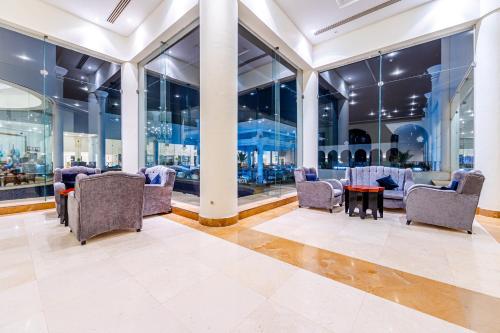 a lobby with chairs and tables and windows at Siva Sharm Resort & SPA in Sharm El Sheikh
