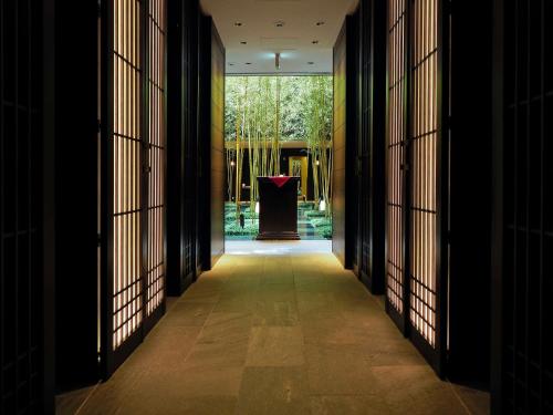 a hallway of a building with a podium in the distance at Dhawa Yura Kyoto in Kyoto