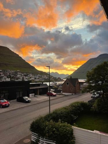 a view of a street with cars parked on the road at Cozy apartment in Klaksvík in Klaksvík
