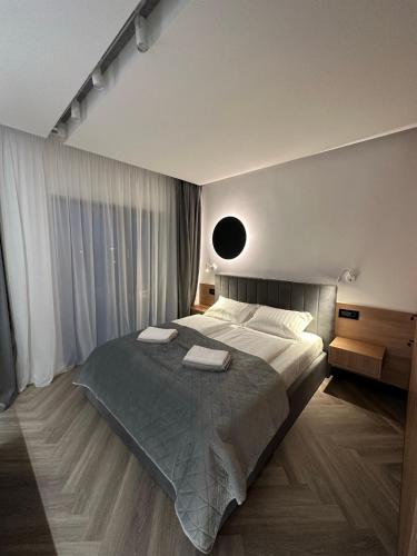 a bedroom with a large bed with two pillows at Luxury by The Lake Ap 28 in Sibiu