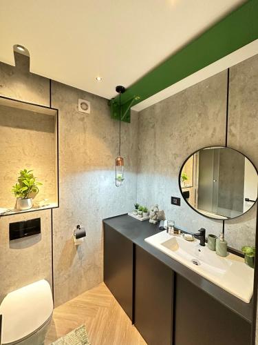 a bathroom with a sink and a mirror at Luxury by The Lake Ap 28 in Sibiu