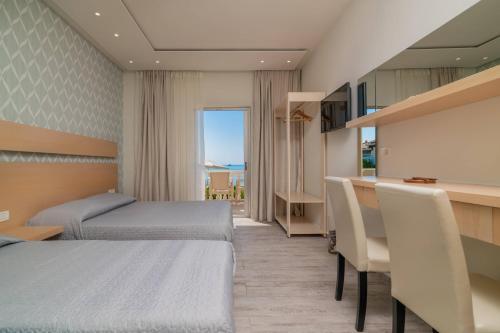 a hotel room with two beds and a bar at Sea View in Laganas