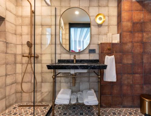 a bathroom with a sink and a mirror at Khai Karaköy in Istanbul