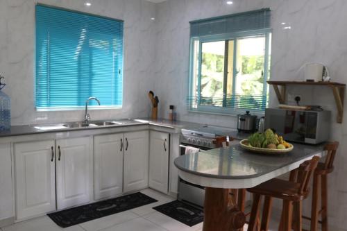 a kitchen with a table with a bowl of fruit on it at FOND B'OFFAY LODGE in Victoria