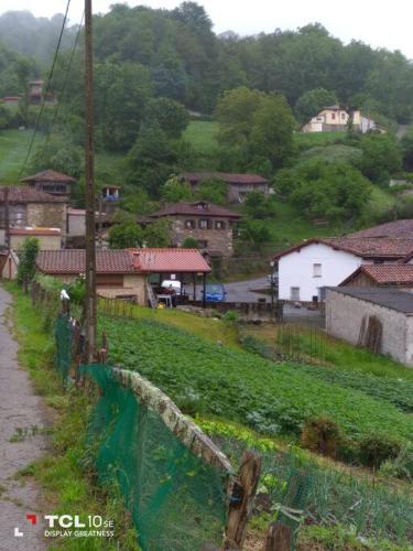 a small village with houses on a hill at La Casa Rectoral de El Tozu in Caso