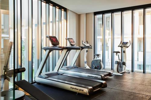 a gym with treadmills and ellipticals in a building at The Yorkshire Apartments Collingwood in Melbourne