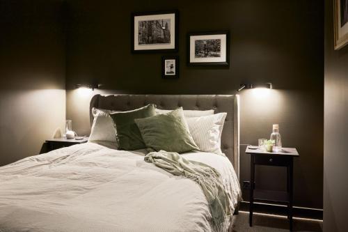 a bedroom with a white bed with two night stands at Brewery Lane in Melbourne