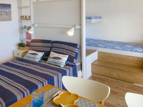 Cette petite chambre comprend un lit et une table. dans l'établissement Apartment Arenes Pyrenees by Interhome, à Canet