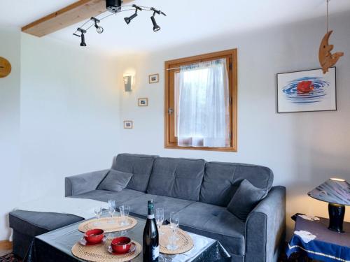 a living room with a couch and a table with wine glasses at Apartment Le Tagre by Interhome in Mémontel