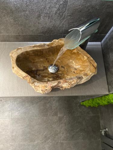 a water fountain in a stone sink in a bathroom at Cinecittà Luxury GUEST HOUSE in Rome