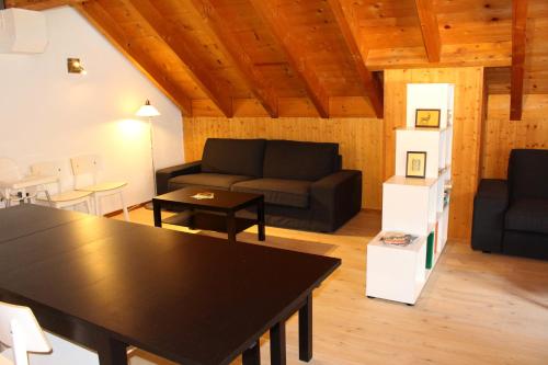 a living room with a couch and a table at La Pierre à Catillon in Moleson