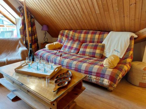 a living room with a couch and a coffee table at Apartment Les Combettes D et E by Interhome in Les Contamines-Montjoie