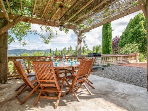 a table and chairs under a pergola with a grill at Holiday Home Les Ecuries by Interhome in Alet-les-Bains
