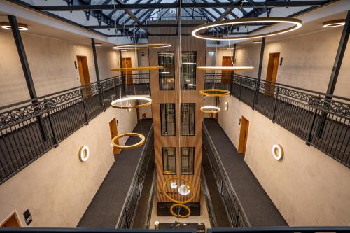 an overhead view of a hallway in a building with lights at Hotel CityHome am Kurpark in Bad Salzuflen