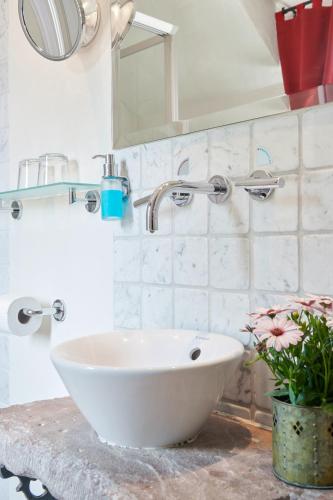 a bathroom with a white sink and a mirror at Hotel Der Grischäfer in Bad Emstal