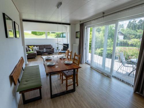 a living room with a table and a couch at Holiday Home Saarland by Interhome in Dittishausen