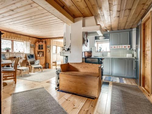 a kitchen with blue cabinets and a wooden ceiling at Chalet Fjällnäs - HJD025 by Interhome in Tänndalen