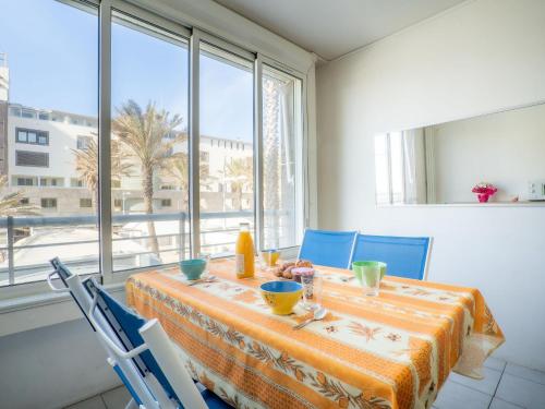 comedor con mesa, sillas y ventana en Apartment Le Sunset-Cap Sud-1 by Interhome, en Cap d'Agde