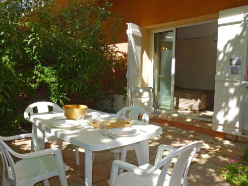 a white table and chairs on a patio at Apartment Les Jardins de Neptune by Interhome in Virebelle