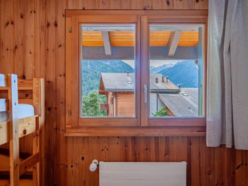a bedroom with a window with a view of a mountain at Apartment Les Crêtes 1-3 by Interhome in Veysonnaz