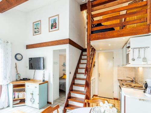 a staircase leading up to the kitchen in a tiny house at Holiday Home Hameau de Talaris-3 by Interhome in La Palmyre