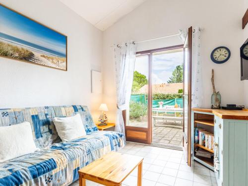 un salon avec un canapé et une table dans l'établissement Holiday Home Hameau de Talaris-3 by Interhome, à La Palmyre