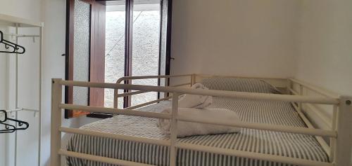 a bunk bed in a room with a window at Casa Andrea in Las Palmas de Gran Canaria