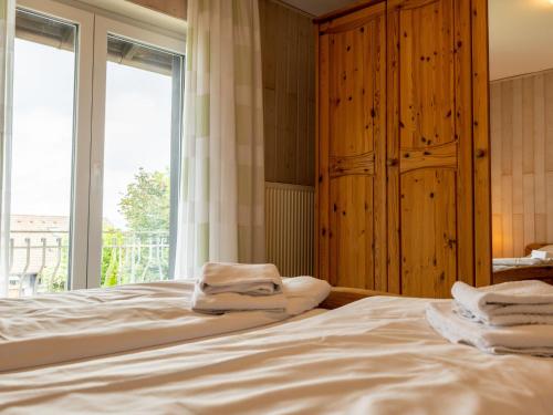 a bedroom with a bed with towels on it at Holiday Home Romeo by Interhome in Dittishausen