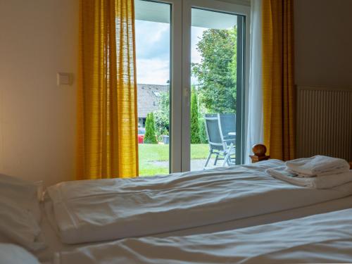 a bedroom with a bed and a large window at Holiday Home Romeo by Interhome in Dittishausen