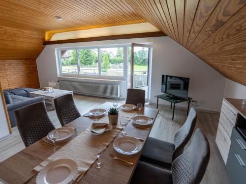 a dining room with a wooden table and chairs at Apartment Hochfirst by Interhome in Dittishausen