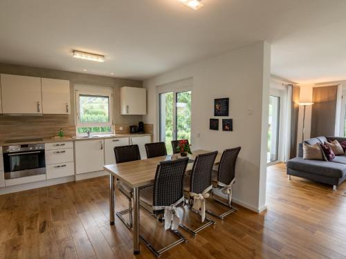 a kitchen and living room with a table and chairs at Holiday Home Ambiente by Interhome in Dittishausen