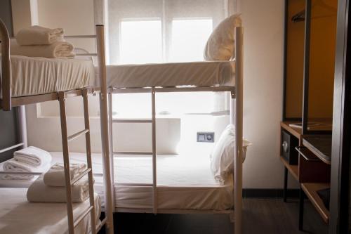 a room with two bunk beds and a window at Letoh Letoh Gran Vía in Madrid