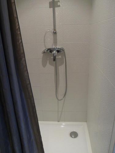 a shower with a shower head in a bathroom at Hotel du Cap in Cap-Ferret