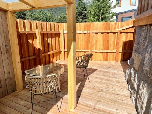 a patio with a table and chairs on a wooden deck at Holiday Home Sky-Chalet by Interhome in Imst