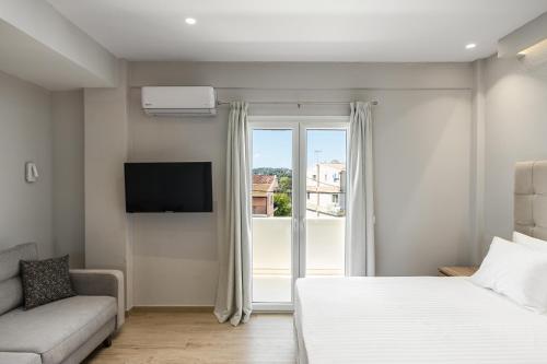 a bedroom with a bed and a large window at solarisuites in Mantoúkion