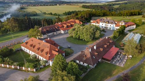 an aerial view of a large house with red roofs at Darovanský Dvůr - Wellness & Golf Hotel in Břasy