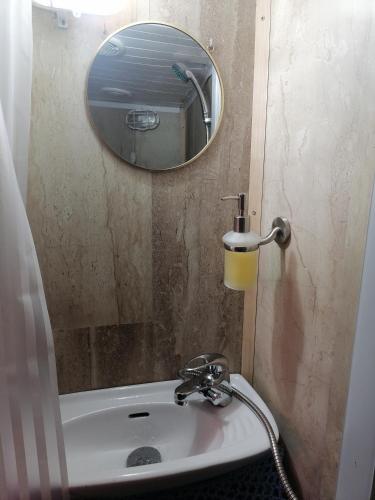 a bathroom with a sink and a mirror at Corabia Santa Marina in Sulina