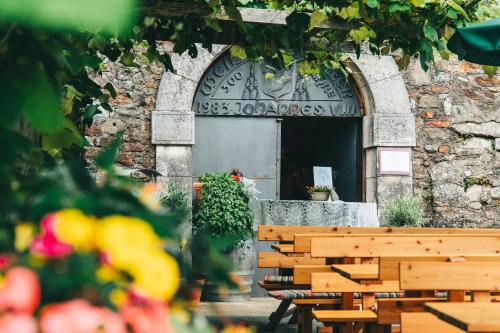 a building with a wooden bench in front of a door at Schloss Seggau in Leibnitz