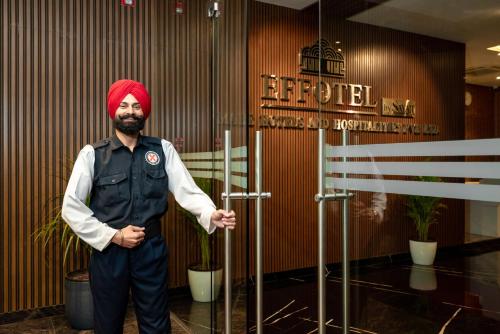 a man with a red turban standing in a lobby at Effotel by Sayaji Sarola in Bhor