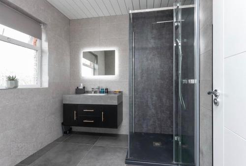 a bathroom with a shower and a sink at Modern home 10 mins to Belfast City in Belfast