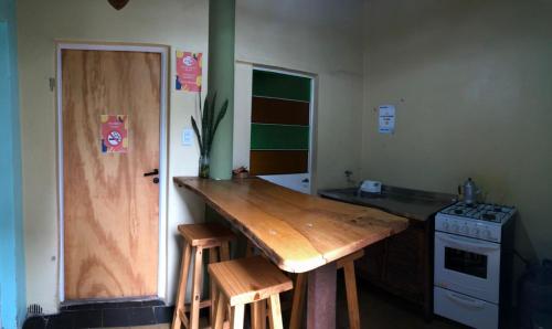 a kitchen with a wooden counter top and a stove at Hostal - Sueños del Rio in Concepción del Uruguay